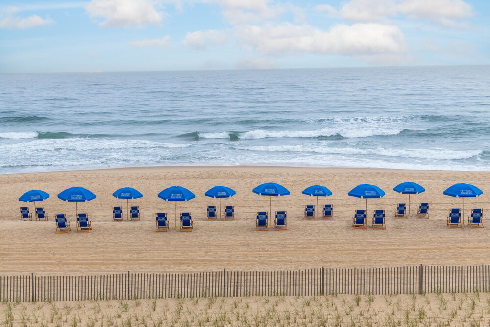 a beach with chairs and umbrellas